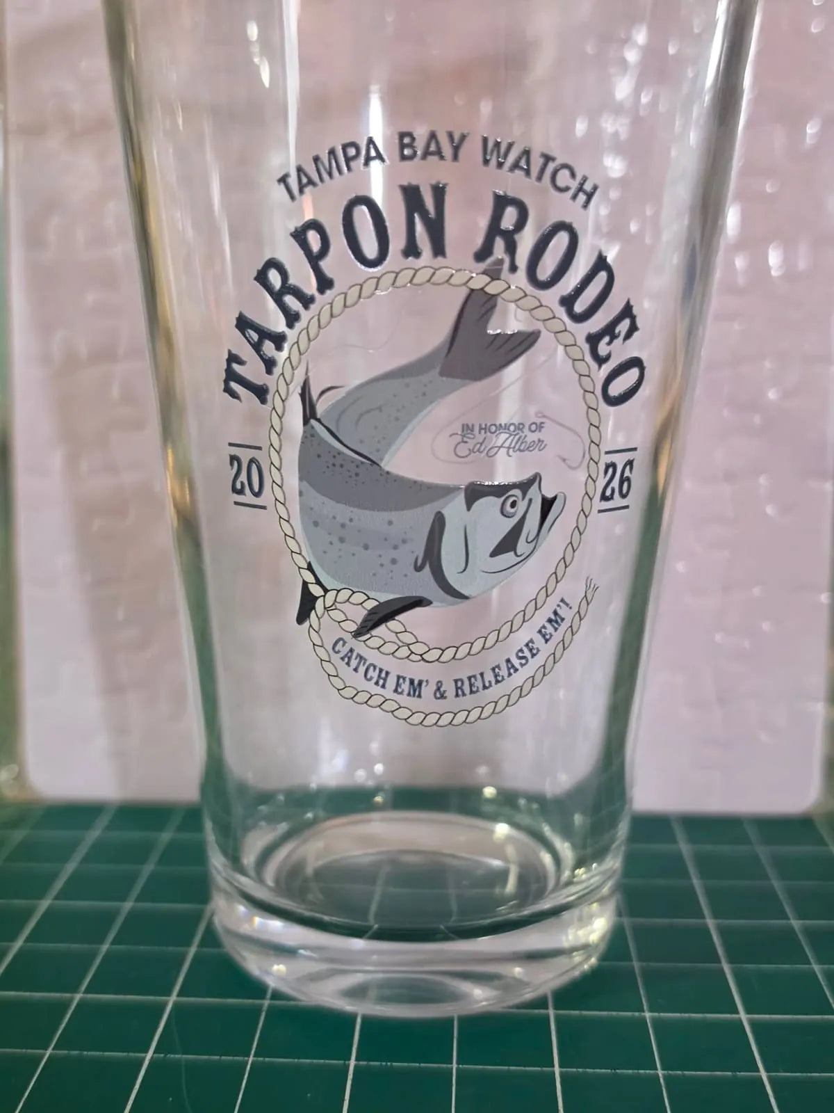 Pint glass printed with the Tampa Bay Watch Tarpon Rodeo 2026 design